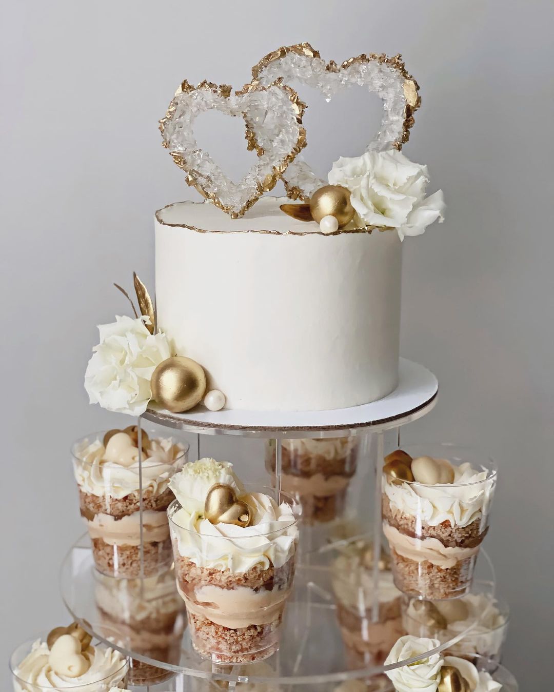 one tier white and gold wedding cake with cupcakes via victoria__desserts