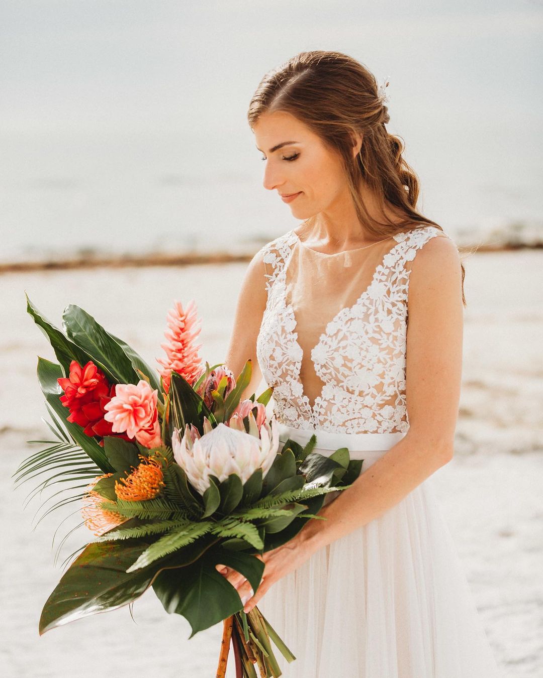 pink protea and greenery tropical beach wedding bouquet via ideweventsflorals