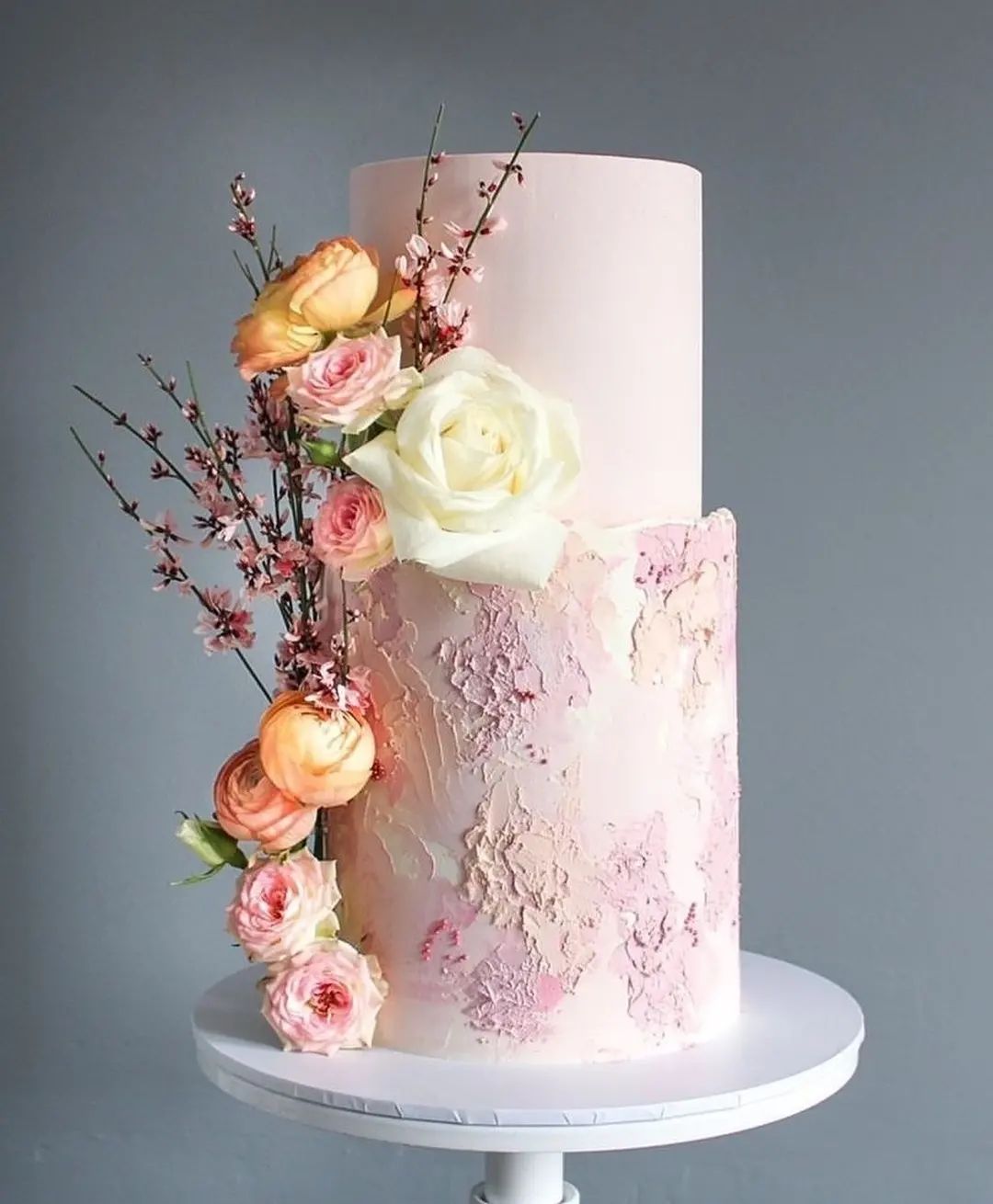 pink wedding cake with peach and pink flowers via taraacakes