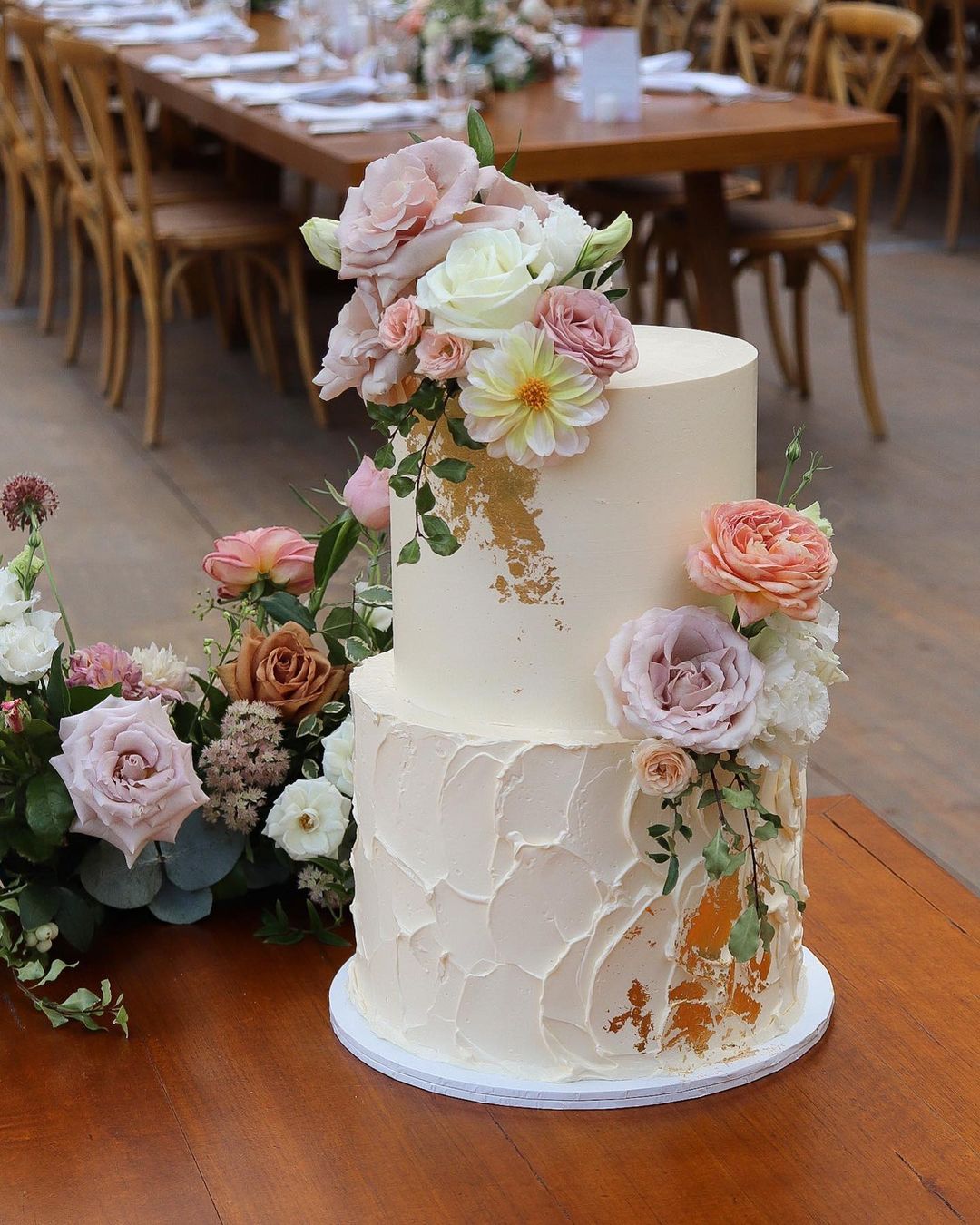 rustic buttercream wedding cake with pink roses via milkandhoney.cakecreative
