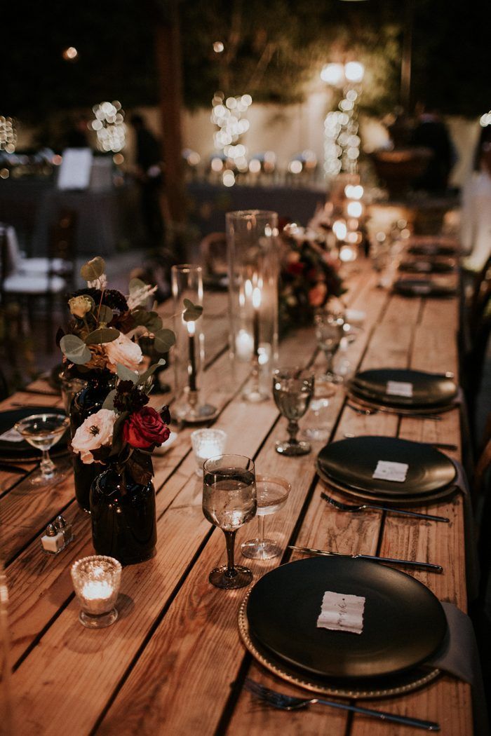 rustic wedding table with simple burgundy and black centerpiece