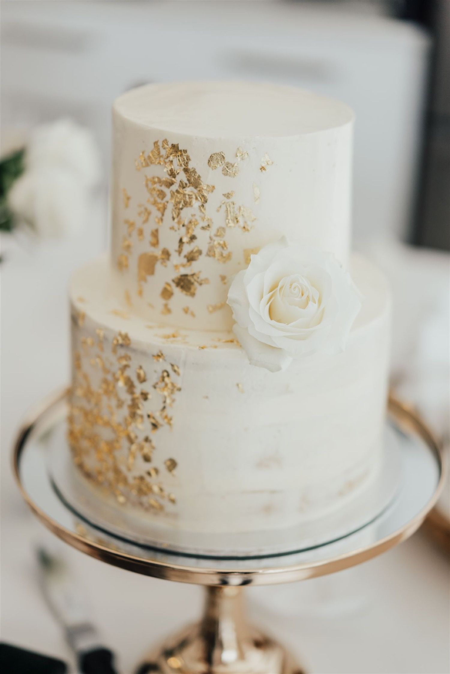 simple gold flakes white wedding cake