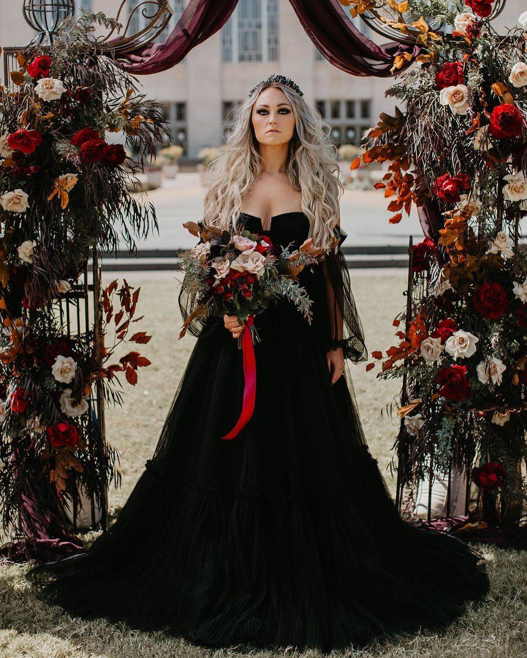 strapless black gothic bridal dress with fall orange halloween arch
