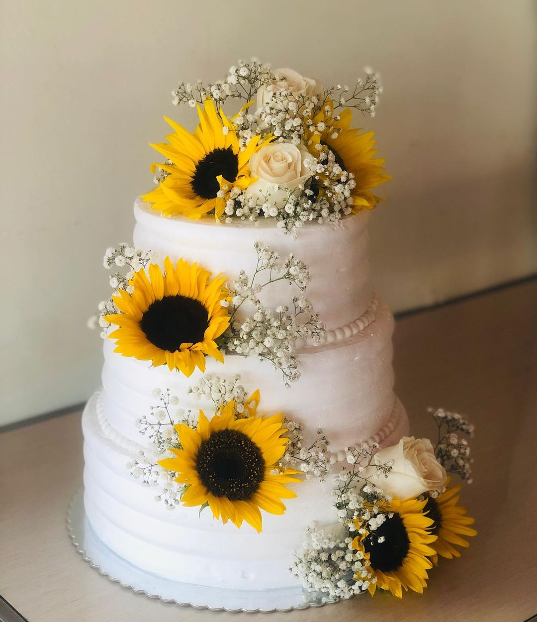 three tier buttercream weding cake with sunflowers and roses via blueberry._pasteleria