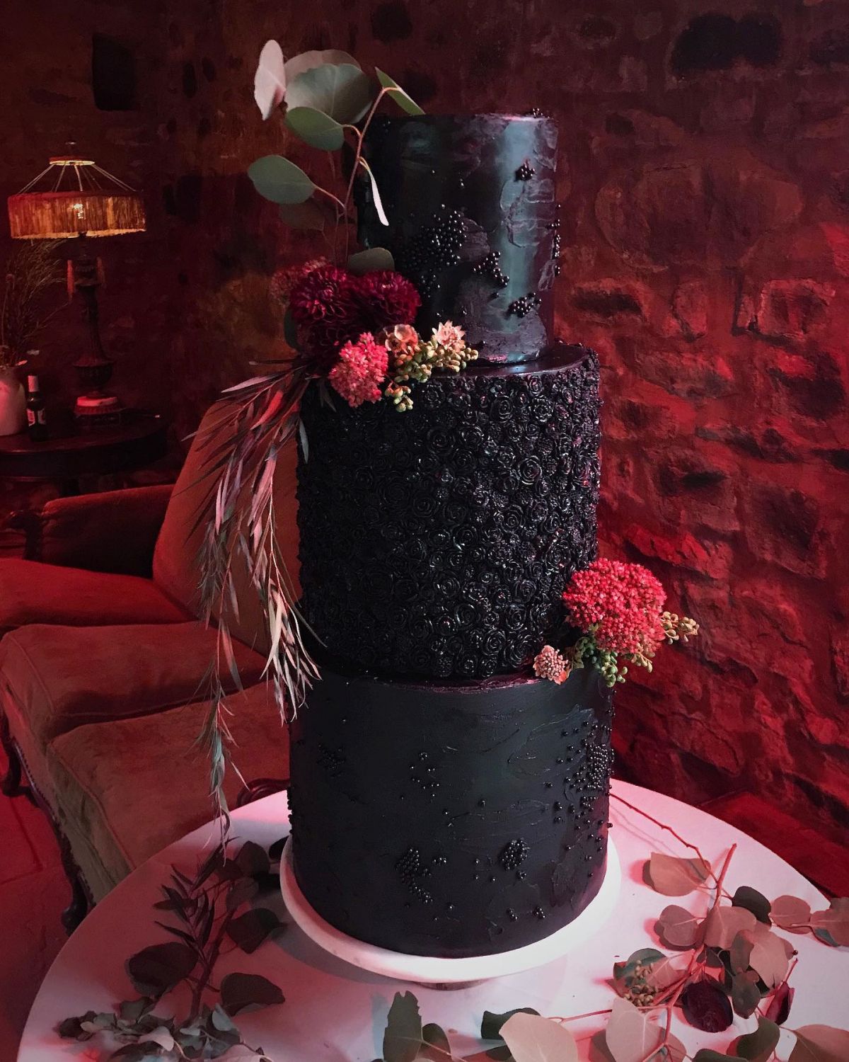 tree tier tall black wedding cake with red flowers