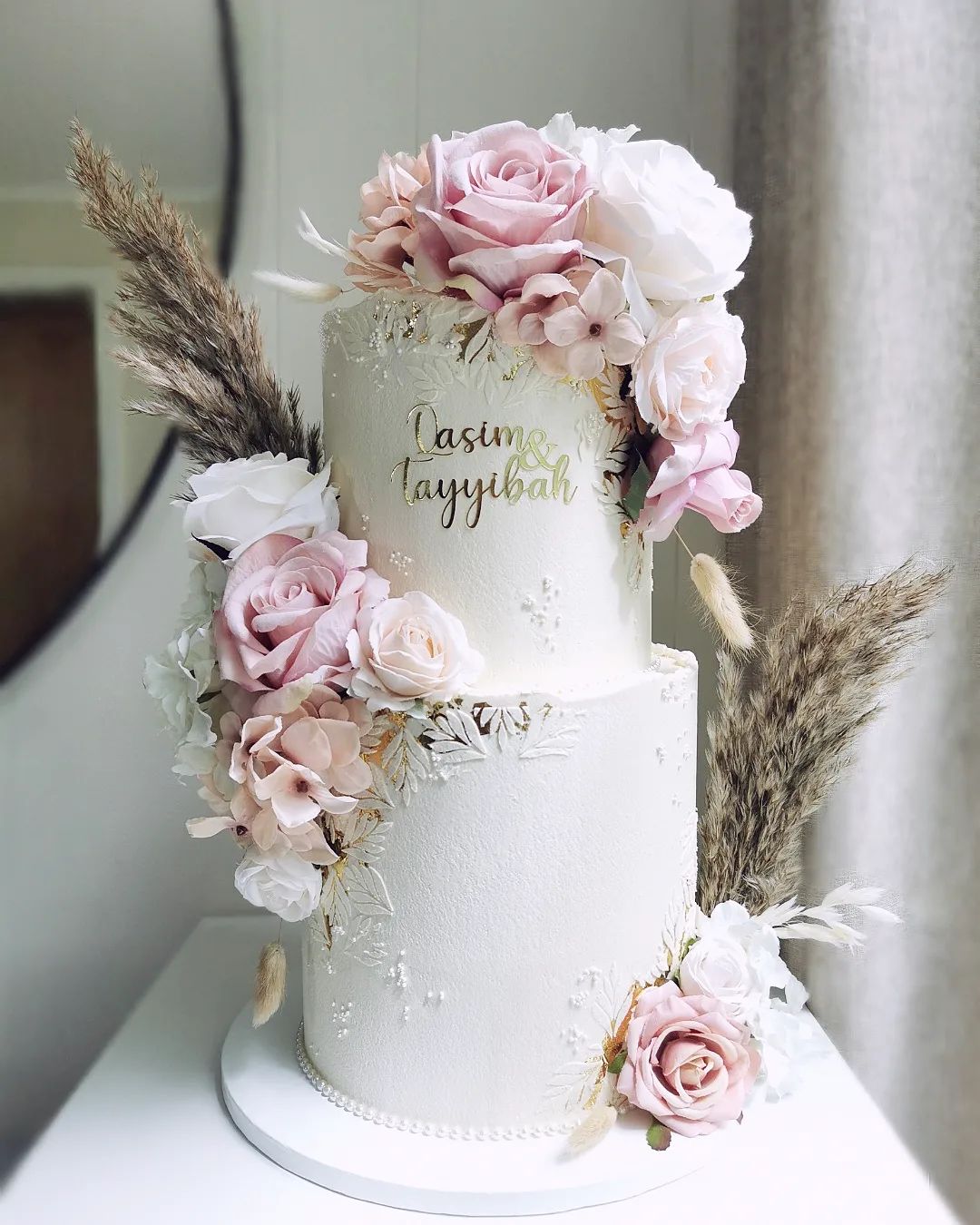 two tier bohemian wedding cake with pink artificial flowers via littlemissfattycakes