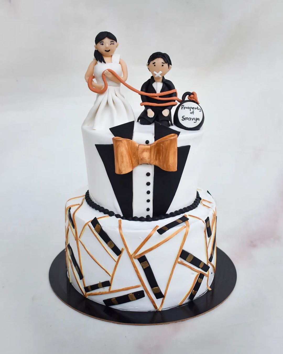 two tier groom cake with cute sugar couple via snohybakeseries
