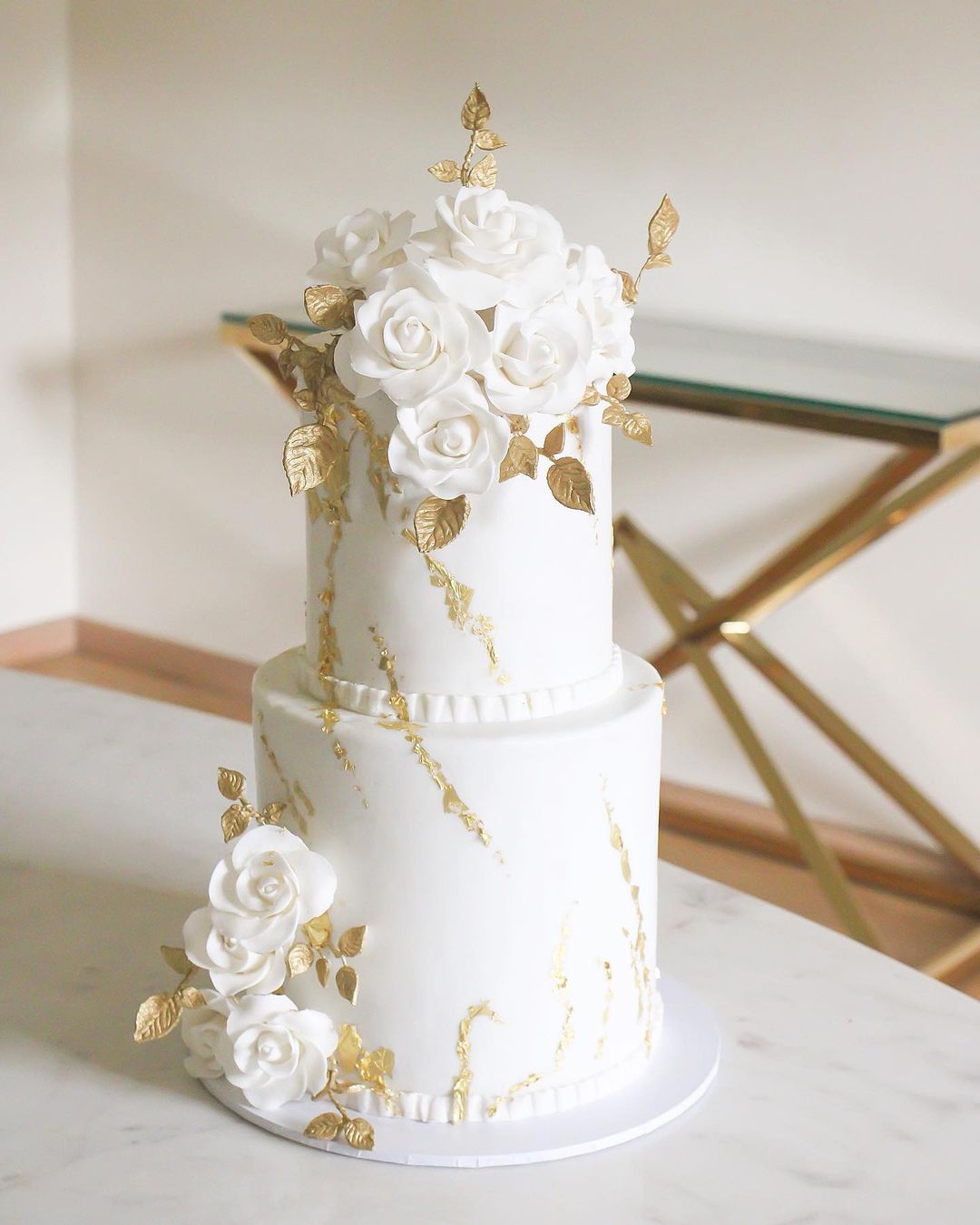 vintage white and gold 2 tier wedding cake with white sugar flowers via delisweet.cakes