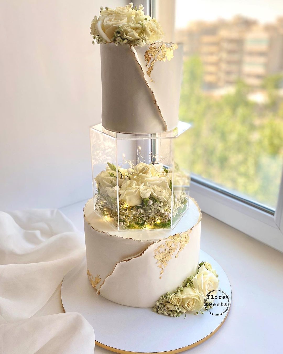 white and gold floating wedding cake with roses via flora___sweets