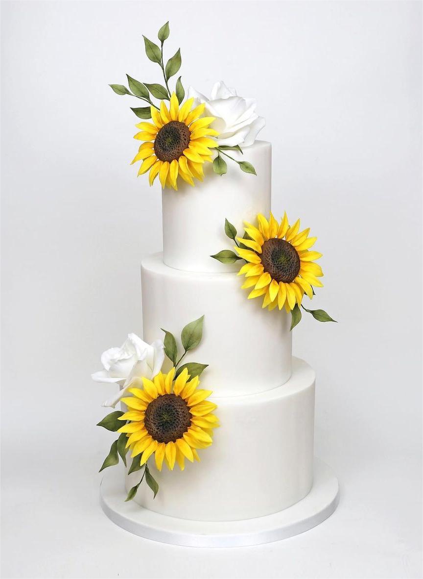 white wedding cake with sunflowers and white sugar roses chrisdancecakes
