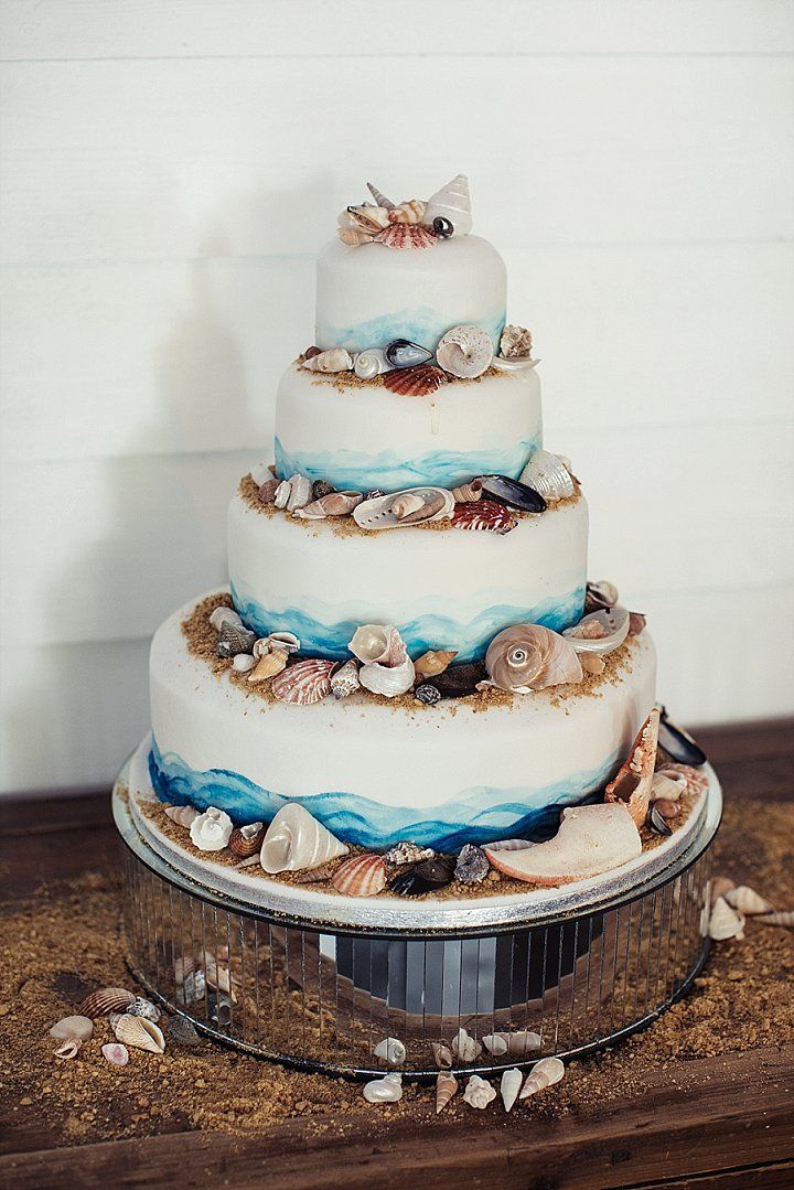4 tier blue beach wedding cake with real starfish and shell