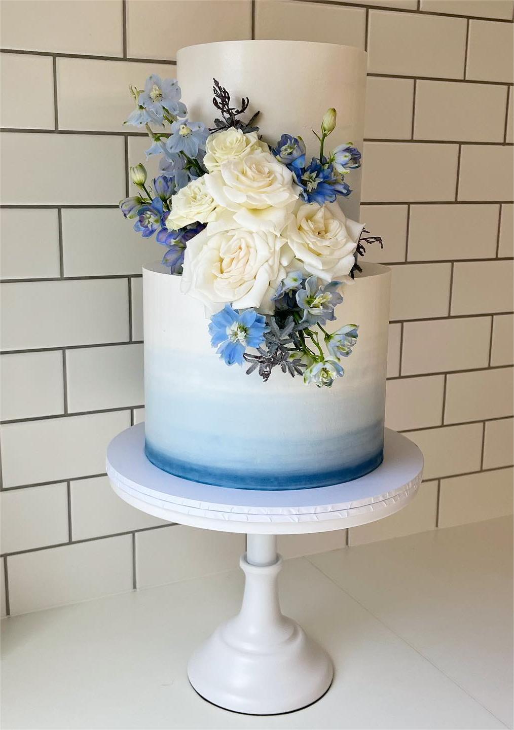 blue ombre wedding cake with blue flowers via copperforkcakes