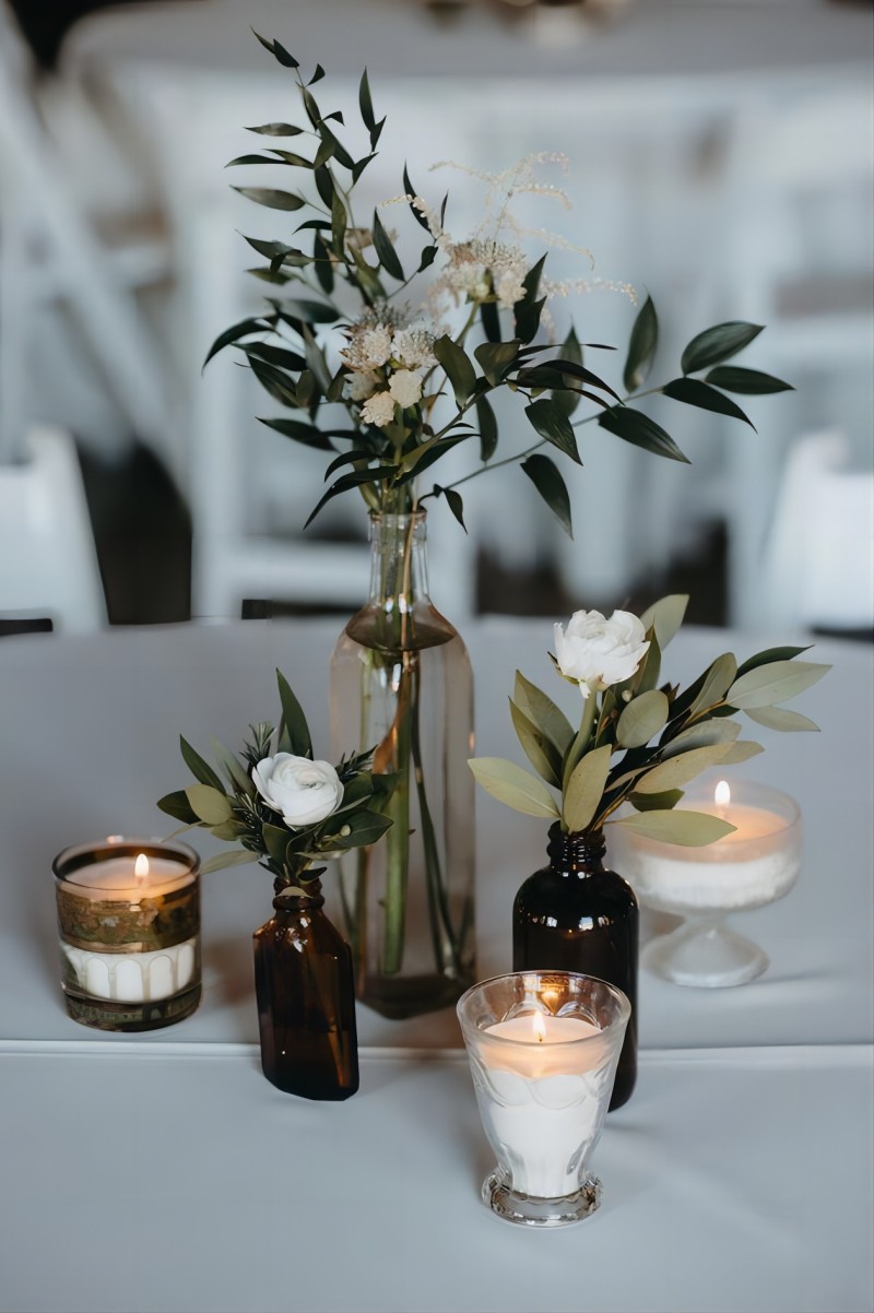 mismatched bottles and greenery simple wedding centerpiece