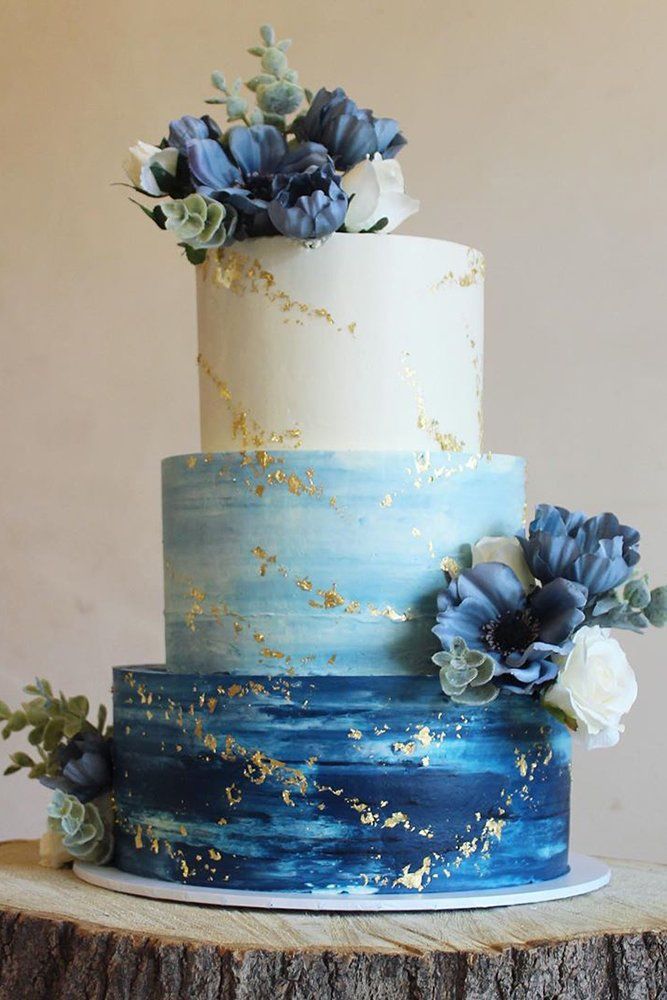 three tier classic blue beach wedding cake with gold glitter
