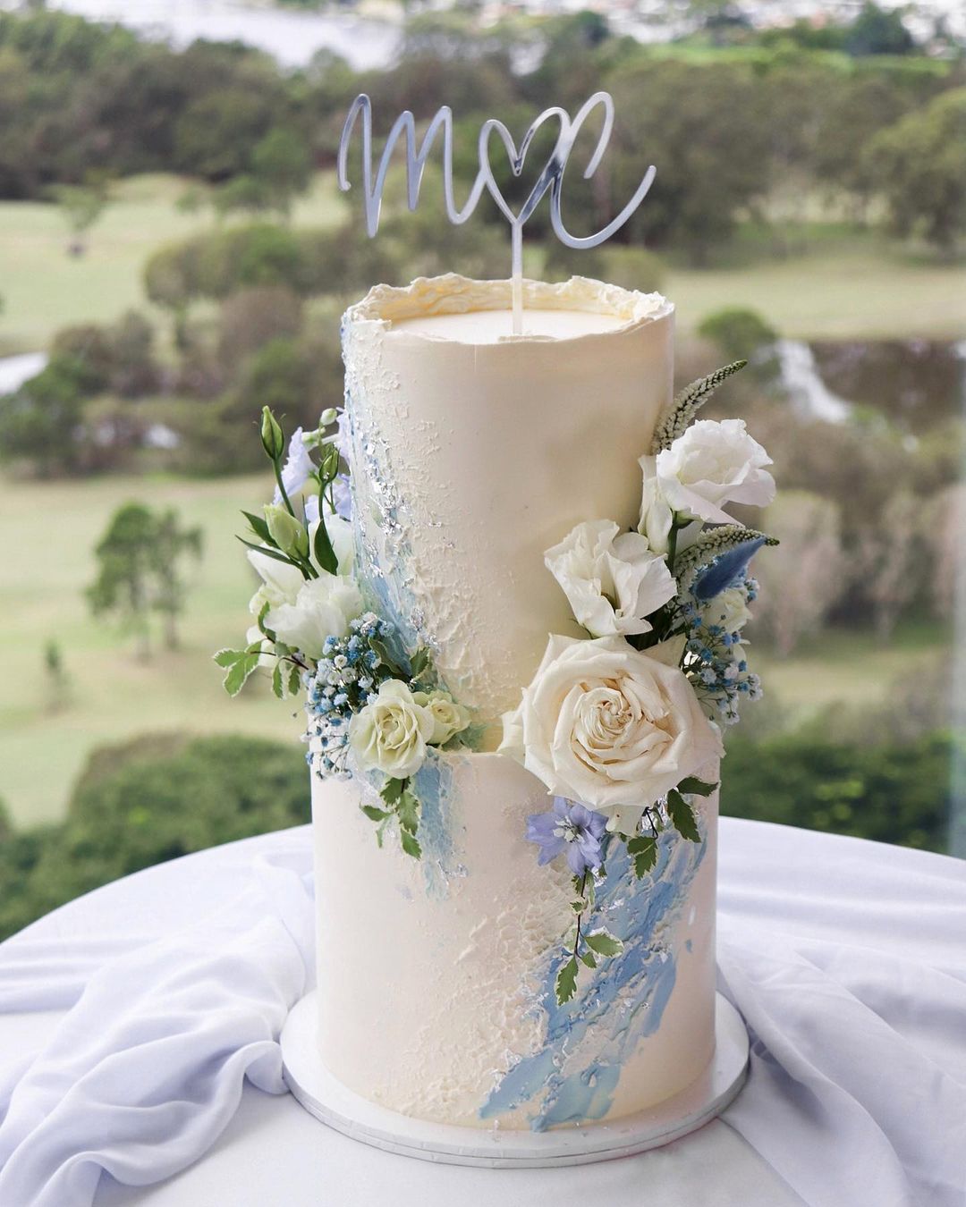 white and light blue wedding cake via milkandhoney.cakecreative