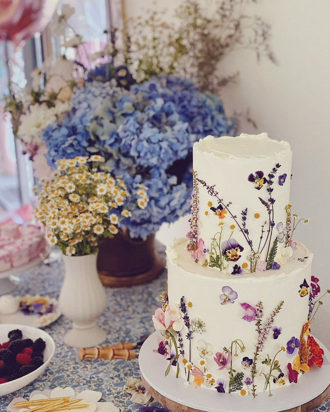 2 tier buttercream wedding cake with colorful flowers via willowgeorgecakeco