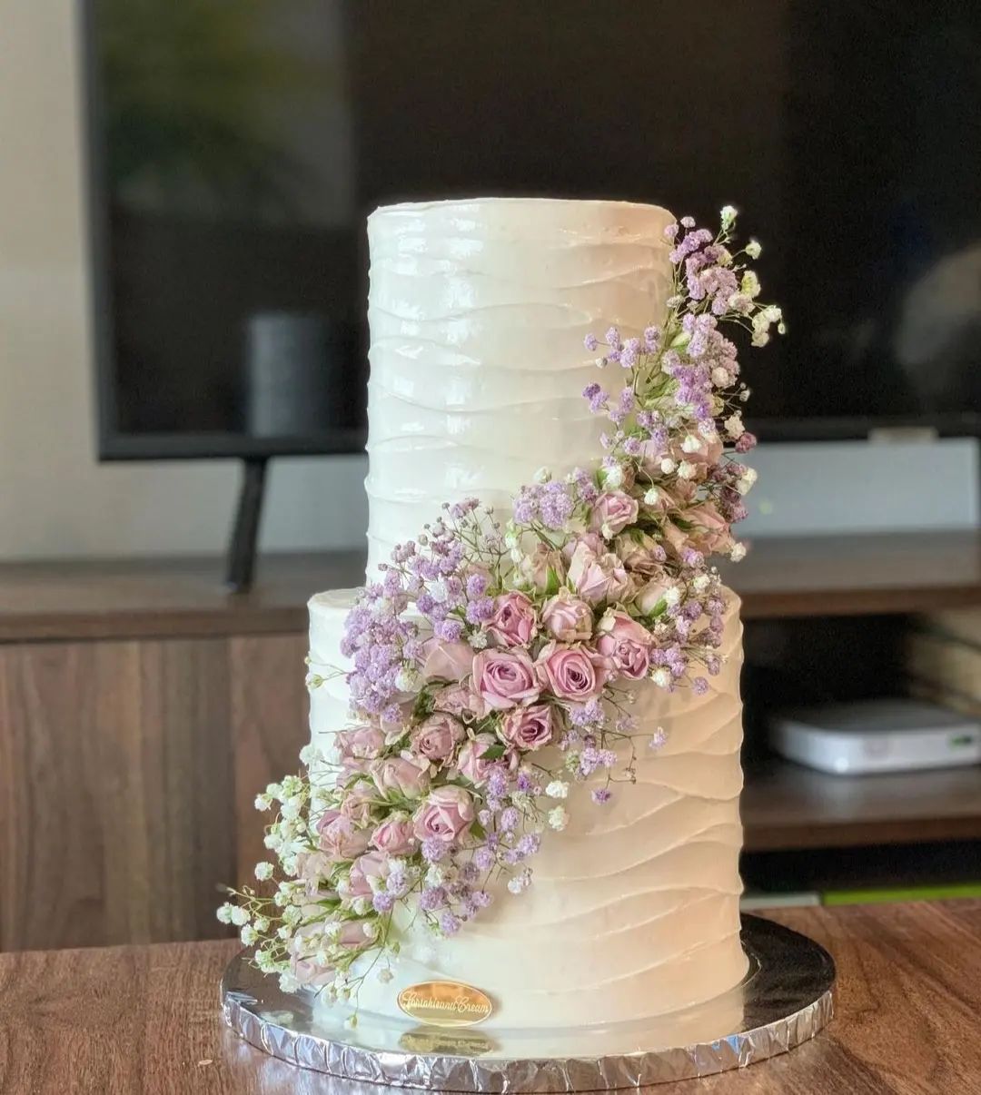 2 tier simple buttercream wedding cake with pink flowers via taraacakes