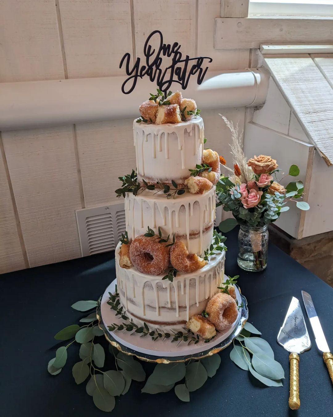 3 tier drip semi-naked wedding cake with mini donuts via mainstreetsweetscakes