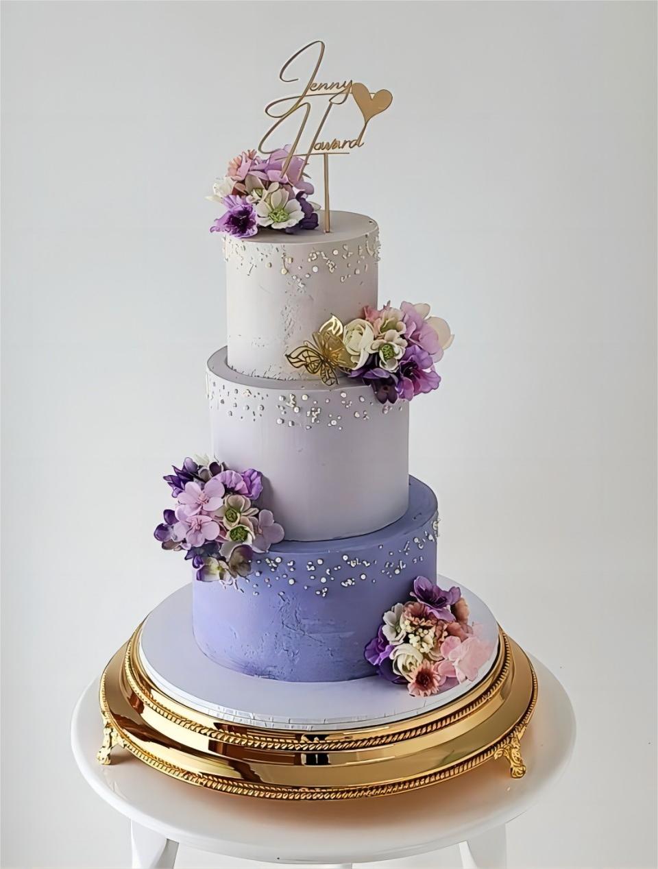 3 tier purple ombre wedding cake with purple flowers via cakeable_vanessa