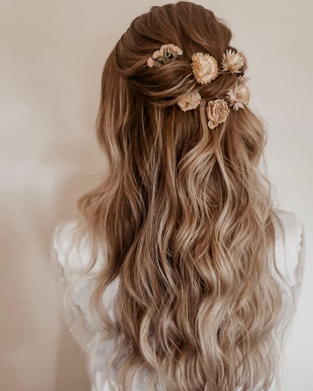 Half up half down homecoming hairstyle with flowers via bridalmuah