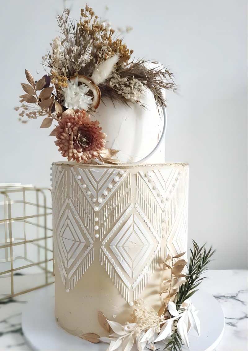 beige bohemian fall wedding cake with dyied leaves decoration