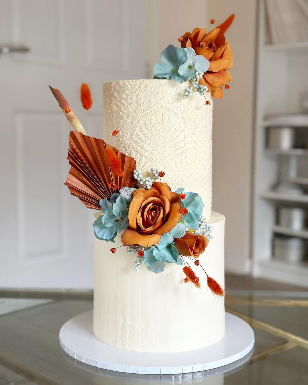 bohemian wedding cake with rust artificial flowers via amelias__cakes