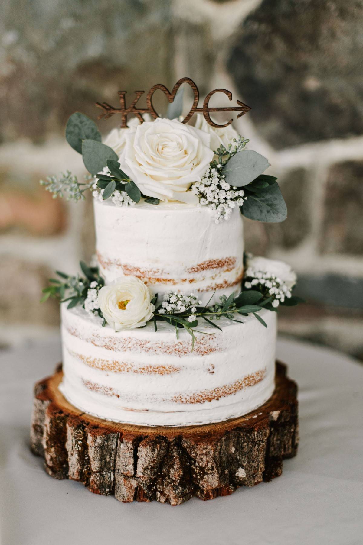 country semi-naked 2 tier wedding cake with greenery