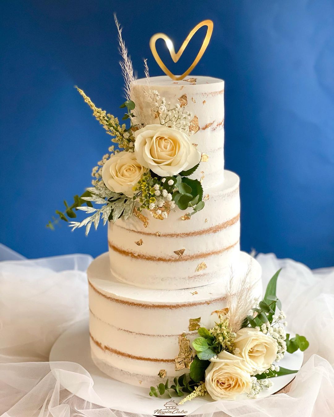 country semi-naked 3 tier wedding cake with roses and gold foil via negin_cake_studio