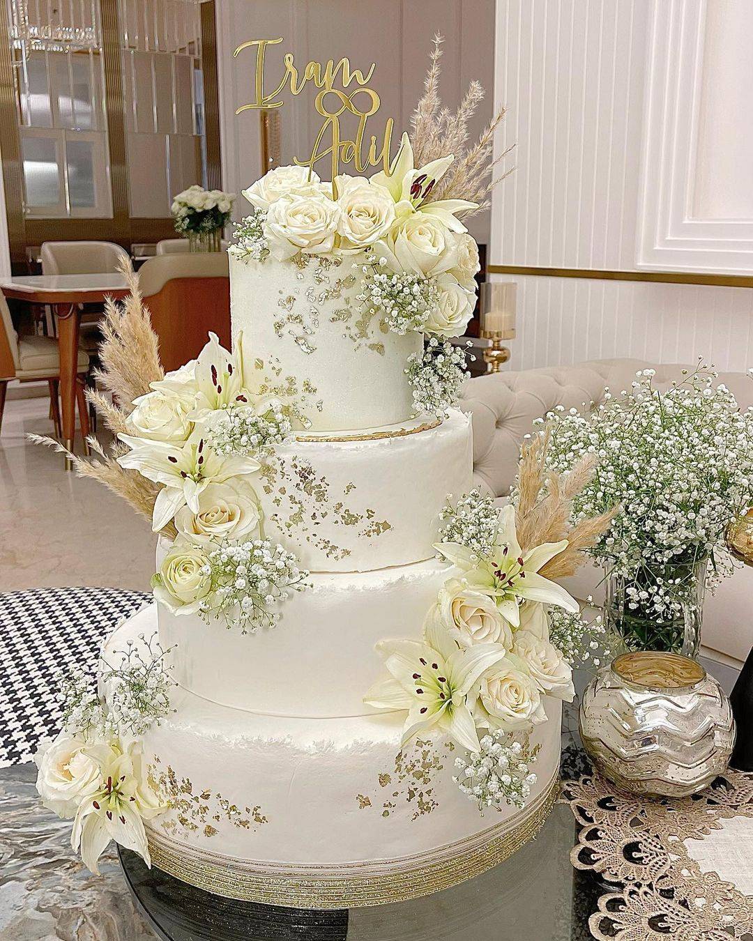 elegant white and gold flakes 4 tier wedding cake via dripsndrizzzles