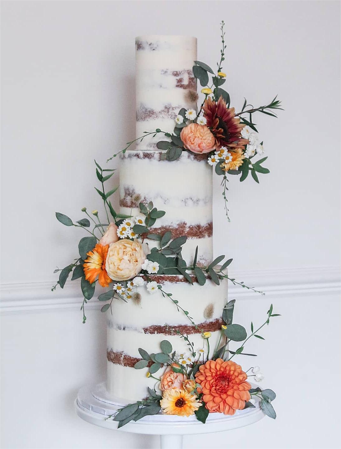 fall country naked wedding cake with orange and burgundy flowers via sallycoopercakeartist