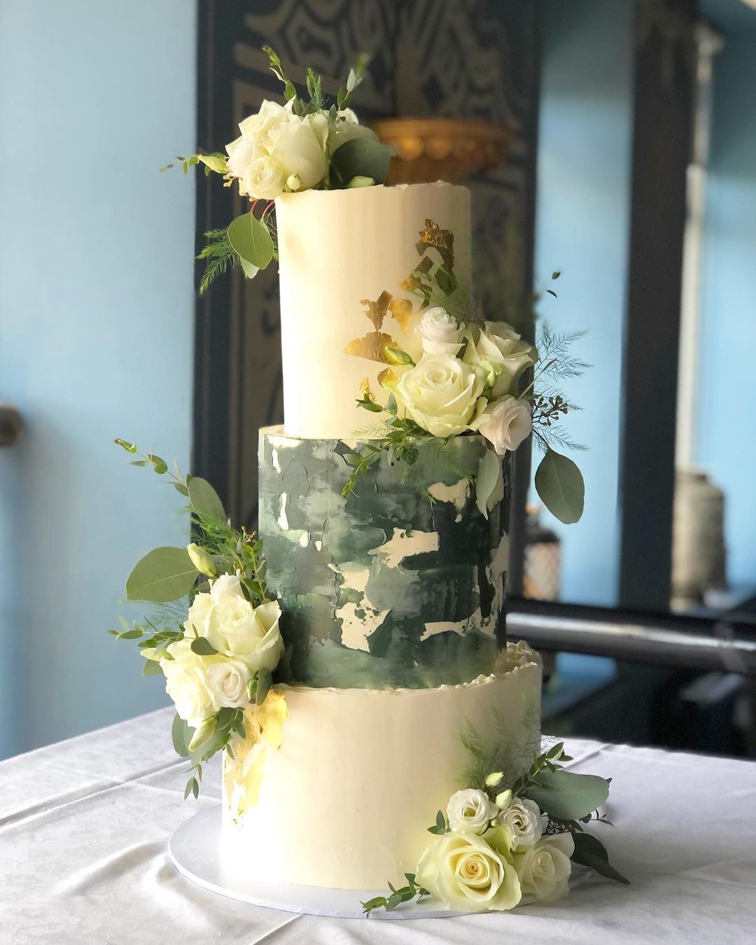 forest green wedding cake with white flowers and eucalyptus via amelias__cakes