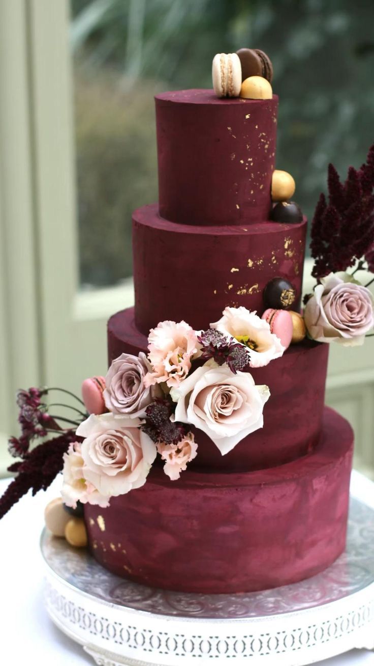 four tier burgundy wedding cake with pink roses