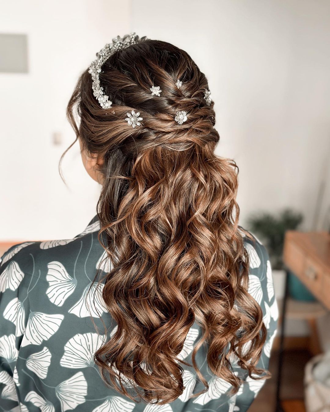 half up half down quinceanera hairstyle with a crown via contimakeup