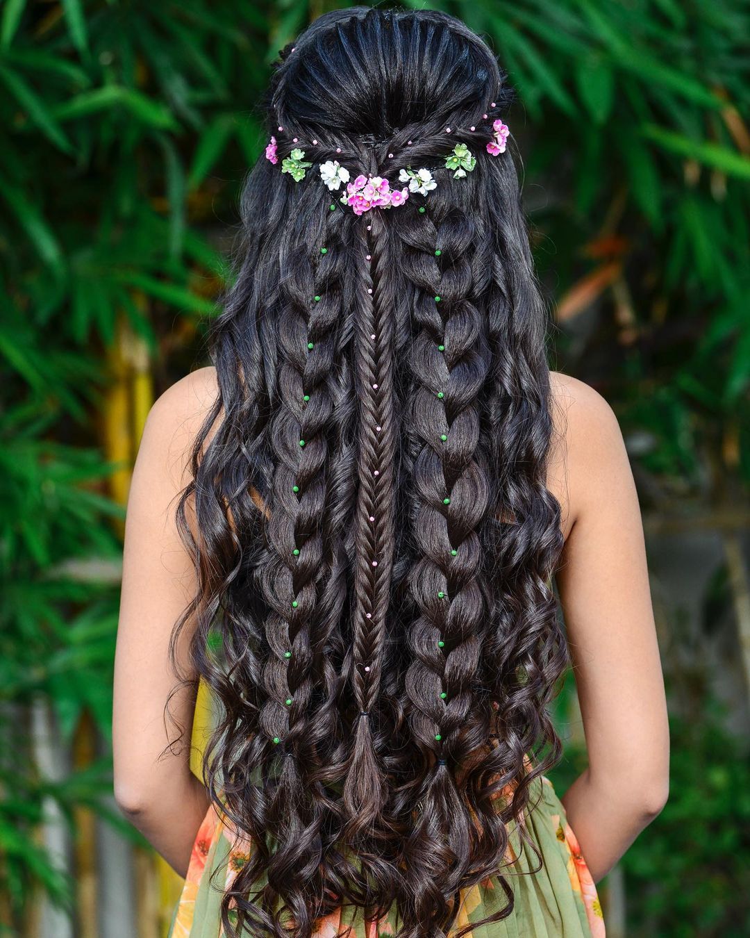 long braided wavy quinceanera hairstyle down with flwoers via crownaayushimakeup