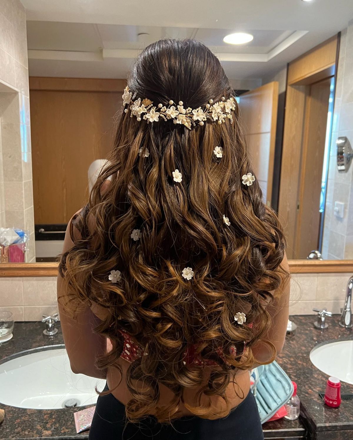 long half up quinceanera hairstyle down with flowers