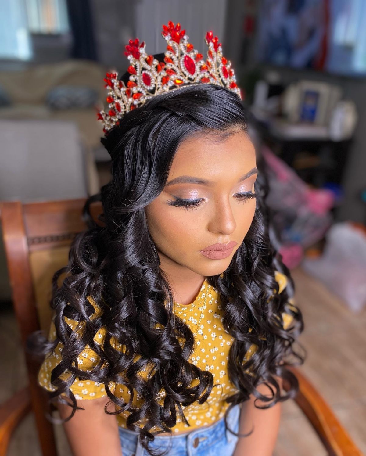 long wavy quinceanera hairstyle down with a red crown