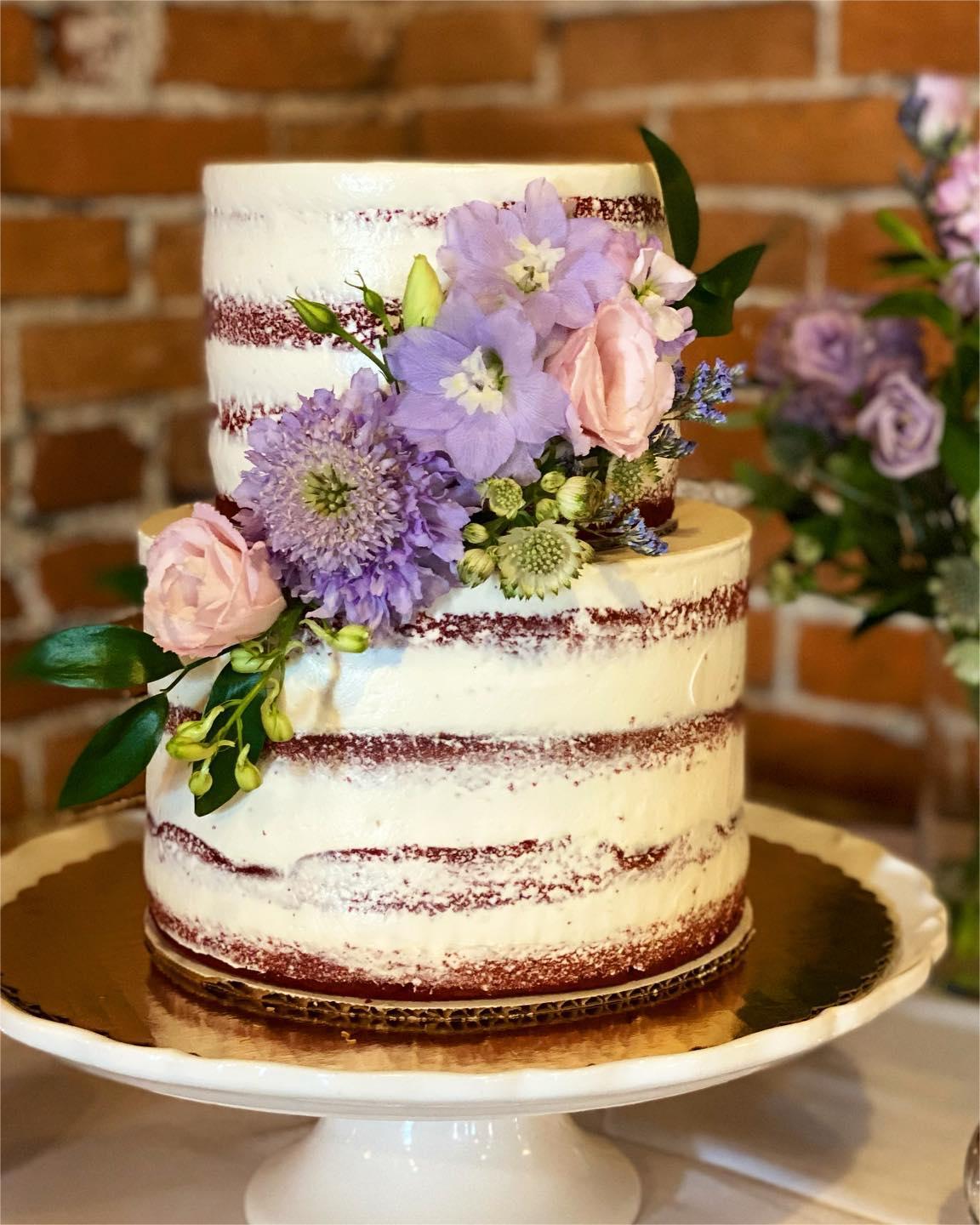 semi-naked red velevt wedding cake with lavdender flowers via katie_cakes_cakery