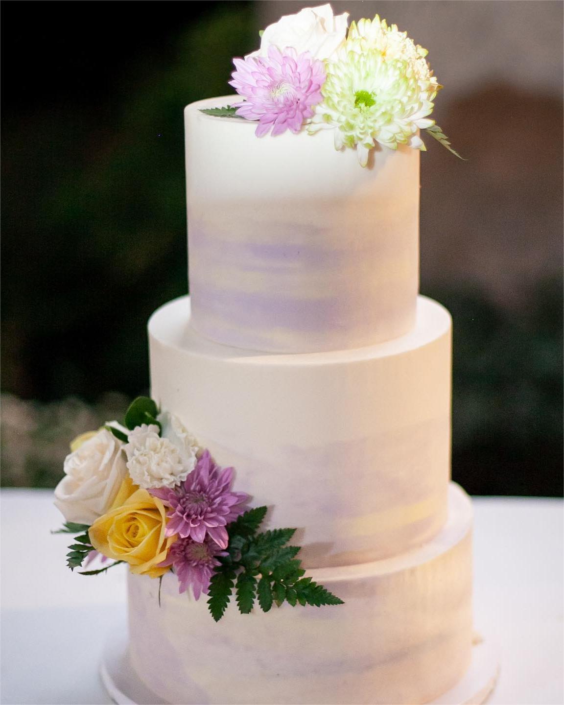 simple 3 tier wedding cake with purple flowers via charleyandco.cakes