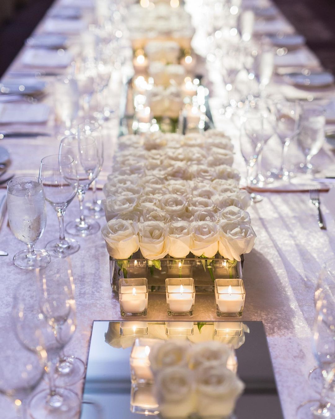 simple white roses in acrylic box wedding centerpiece