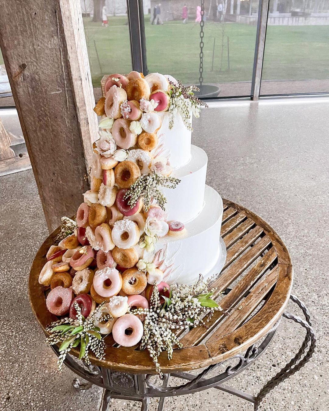 three tier wedding cake with mini donut decorating via events_on_citrus