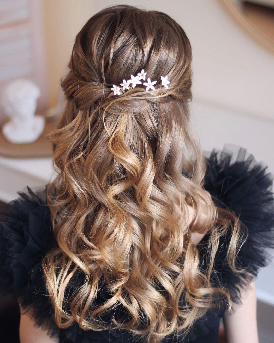 twisted half up half down homecoming hairstyle with hairpiece