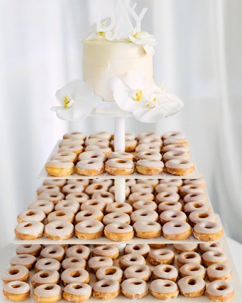 white buttercream wedding cake with donuts