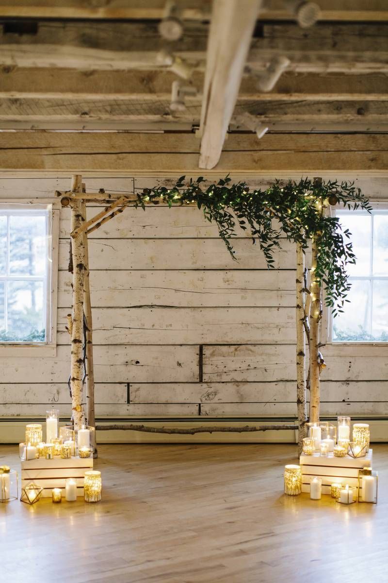 Chic easy rustic birch wedding arch with greenery and candles