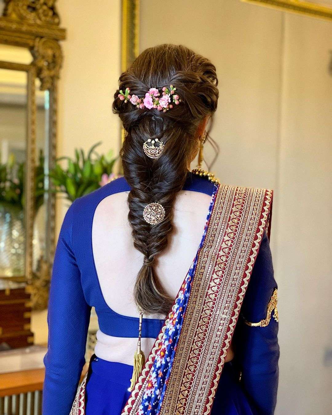 Simple braid with beautiful flowers and jewellery indian wedding hairstyle