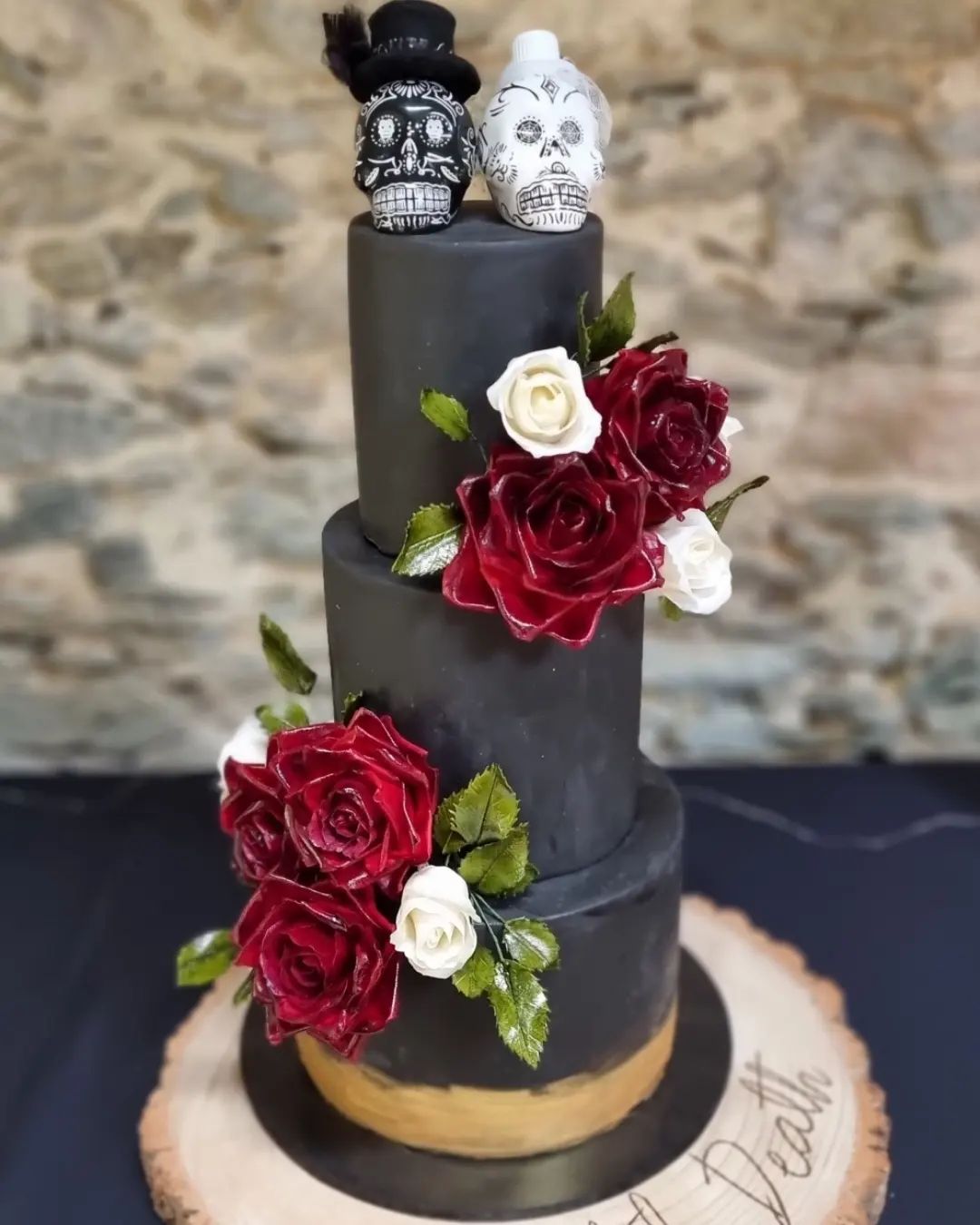 black and burgundy Halloween weddingcake with couple skull topper via ninascakecabin