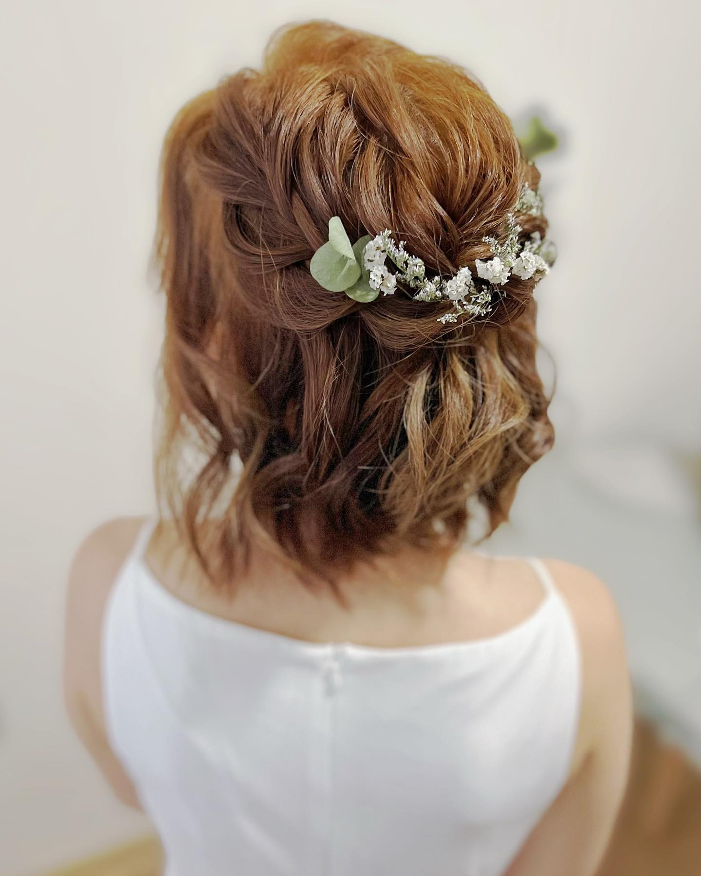 briaided half up half down prom hairstyle with flowers for short hair
