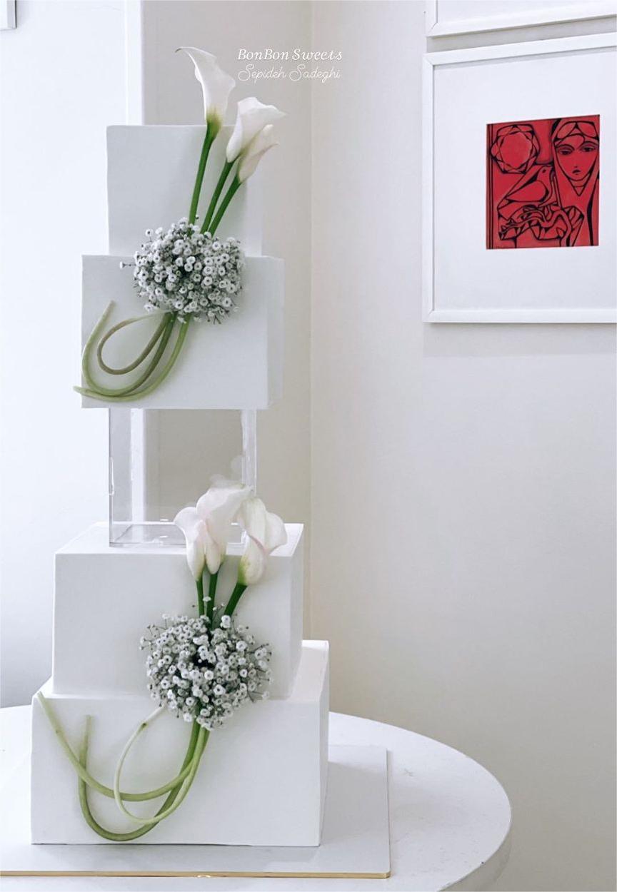 elegant 4 tier square wedding cake with baby's breath and lilies via bonbon_sweets_yazd