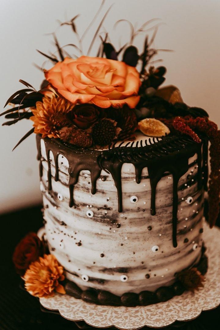 fall rustic semi-naked one tier halloween wedding cake with terracotta flowers
