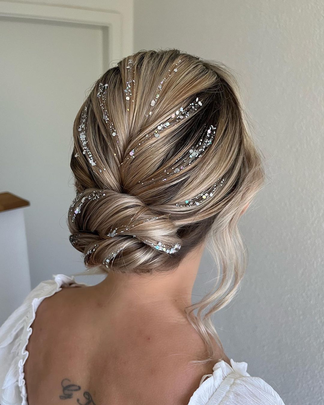 glitter twisted low bun hairstyle via jeny.stylist