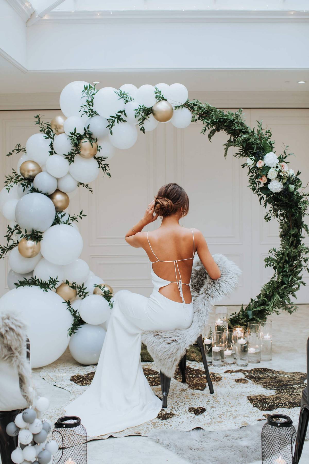 half greenery and half white balloons moon wedding arch